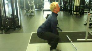 man-demonstrating-a-squat