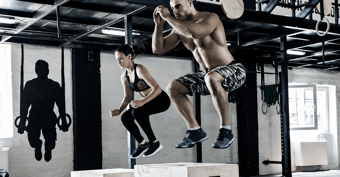 clients-doing-box-jumps-at-crossfit-type-gym